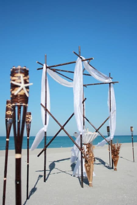 Forever Yours chocolate black bamboo in white and brown beach wedding package with starfish and kissing balls | florida sun weddings