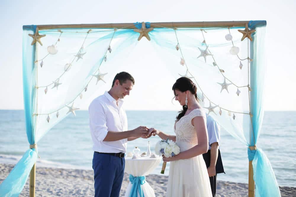 Draped Wedding Arch in Aqua with Starfish Accents for Florida Beach Wedding Ceremony