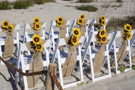 White chairs with burlap and sunflowers | rustic fall beach wedding in Florida