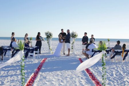 Elegant Black and White Beach Wedding with Column Accents and Red Flower Petals