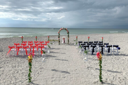 Dual-Color Beach Wedding Ceremony with Floral Arch in Coral and Navy | Florida Oceanfront Weddings