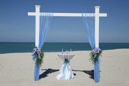Blue Draped White Post Arch for Florida Beach Wedding | Affordable Beach Weddings in Florida