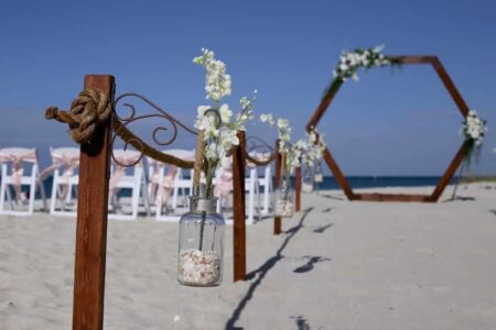 Rustic Modern Beach Wedding Design with roped aisle and wooden hexagon framed backdrop