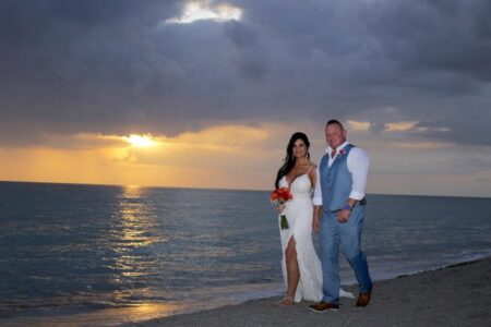 Newlyweds Walk on Florida Beach At Sunset