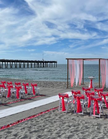 Whispering Sands beach wedding package in coral and white at Sharky's Pier