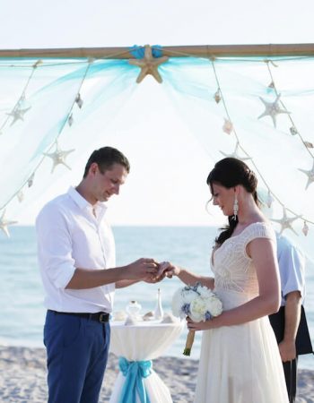 Draped Wedding Arch in Aqua with Starfish Accents for Florida Beach Wedding Ceremony